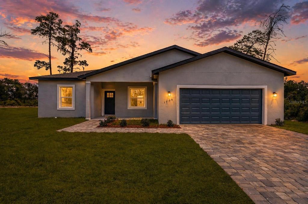 17109 Southwest 41st Circle Ocala, FL 34473 - Photo 2 of 72 a front view of a house with a yard and garage
