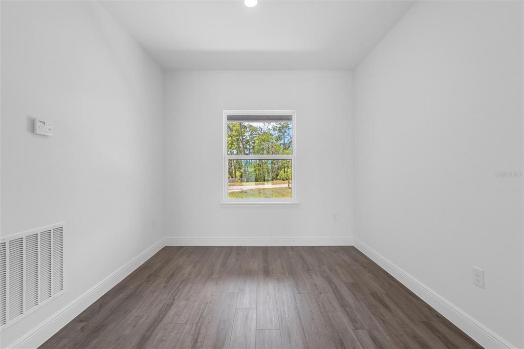 17109 Southwest 41st Circle Ocala, FL 34473 - Photo 27 of 72 wooden floor in an empty room with a window