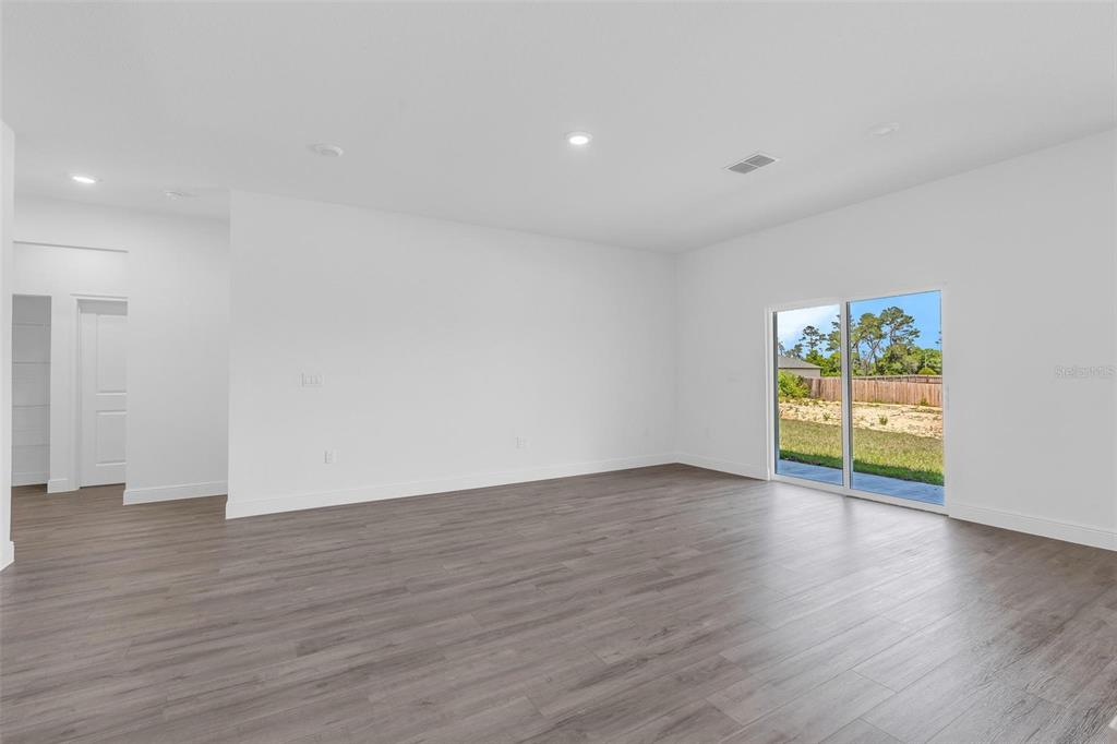 17109 Southwest 41st Circle Ocala, FL 34473 - Photo 29 of 72 a view of an empty room with wooden floor and glass door
