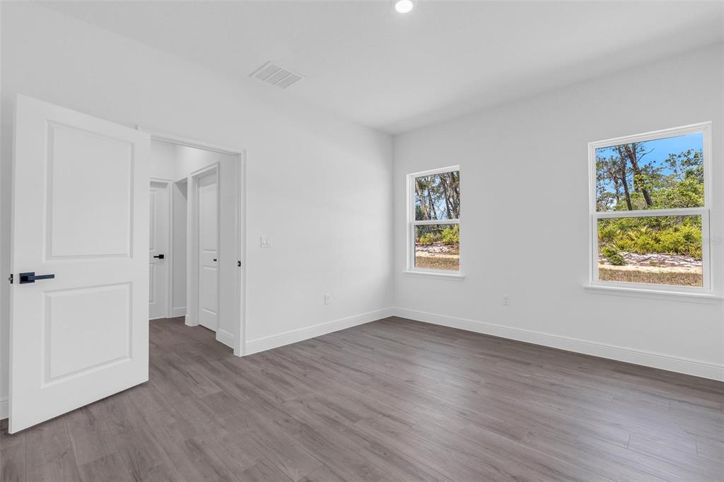 17109 Southwest 41st Circle Ocala, FL 34473 - Photo 30 of 72 an empty room with wooden floor and windows