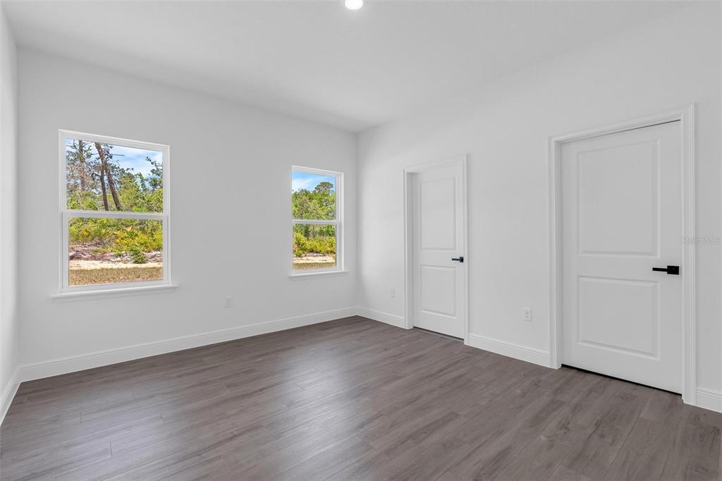 17109 Southwest 41st Circle Ocala, FL 34473 - Photo 31 of 72 an empty room with window and wooden floor