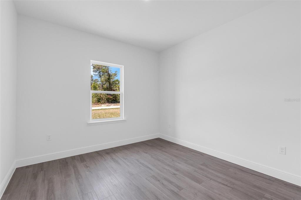 17109 Southwest 41st Circle Ocala, FL 34473 - Photo 40 of 72 an empty room with wooden floor and window