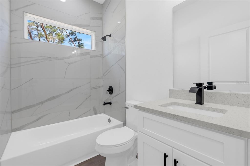 17109 Southwest 41st Circle Ocala, FL 34473 - Photo 47 of 72 a bathroom with a sink a toilet and a bathtub
