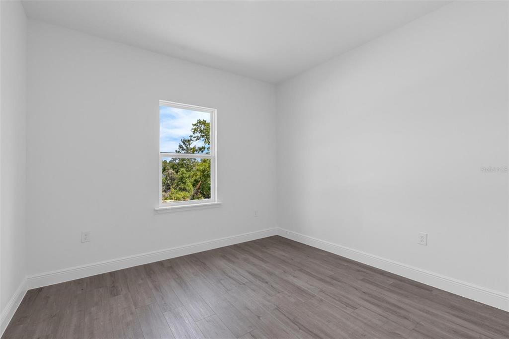17109 Southwest 41st Circle Ocala, FL 34473 - Photo 48 of 72 an empty room with wooden floor and window