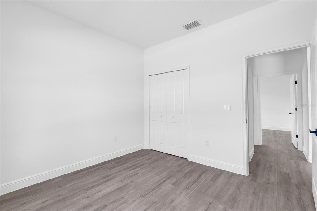 17109 Southwest 41st Circle Ocala, FL 34473 - Photo 50 of 72 a view of an empty room with wooden floor
