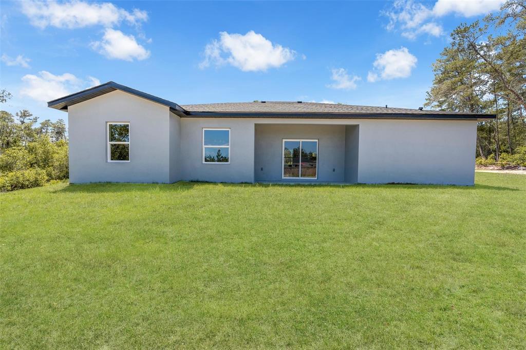 17109 Southwest 41st Circle Ocala, FL 34473 - Photo 56 of 72 a view of a house with a yard