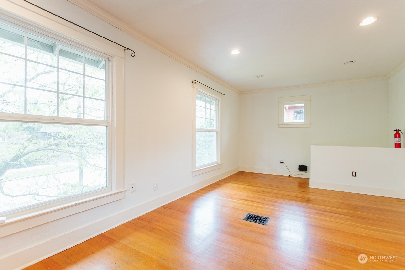 4122 Whitman Avenue North Seattle, WA 98103 - Photo 12 of 28 a view of empty room with wooden floor and fan