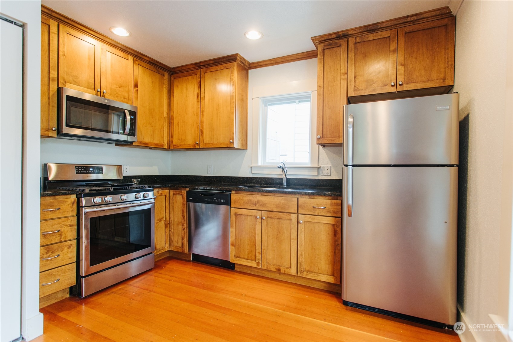 4122 Whitman Avenue North Seattle, WA 98103 - Photo 14 of 28 a kitchen with stainless steel appliances granite countertop a refrigerator stove top oven and sink