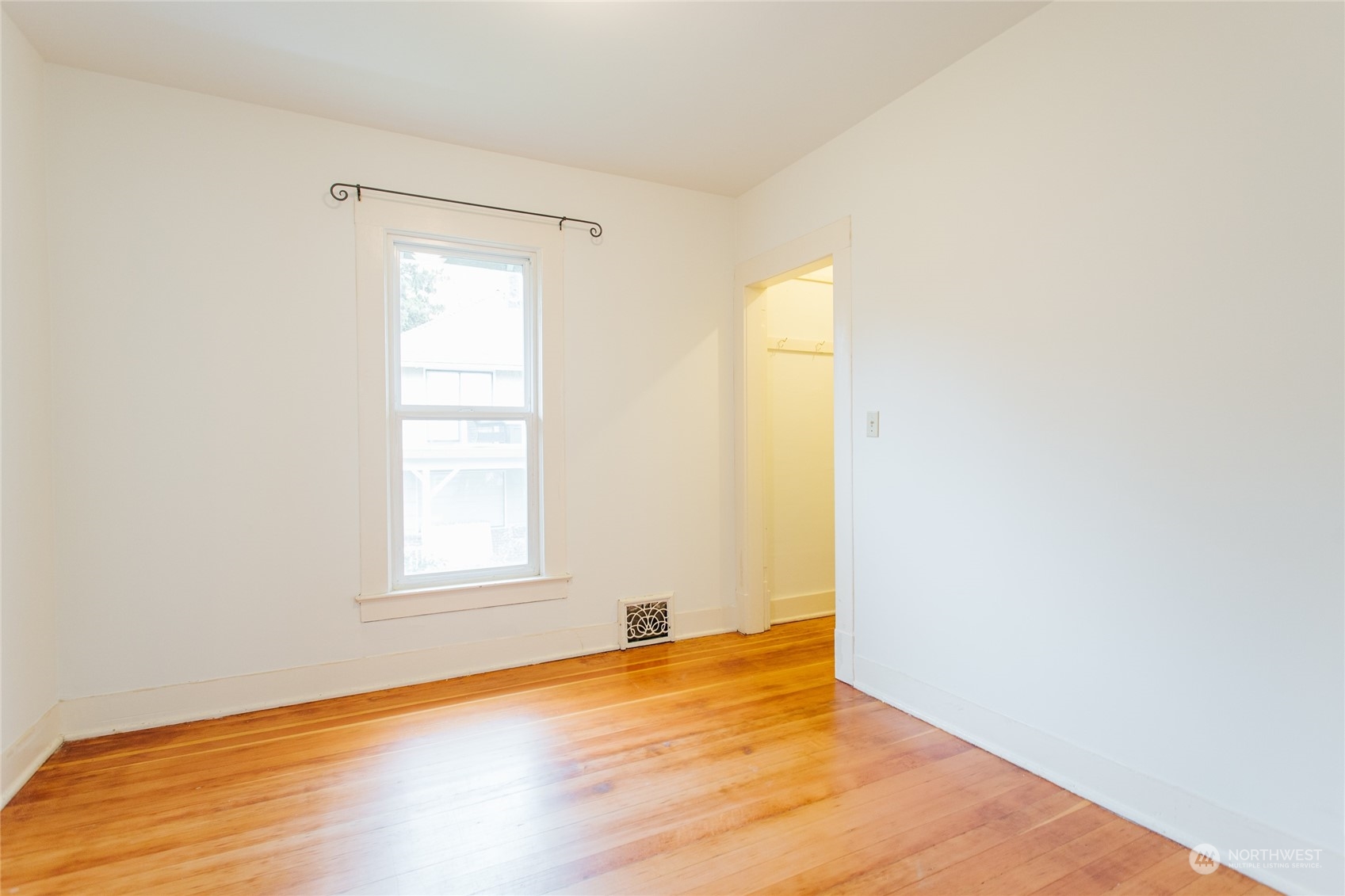 4122 Whitman Avenue North Seattle, WA 98103 - Photo 21 of 28 a view of empty room with wooden floor and fan