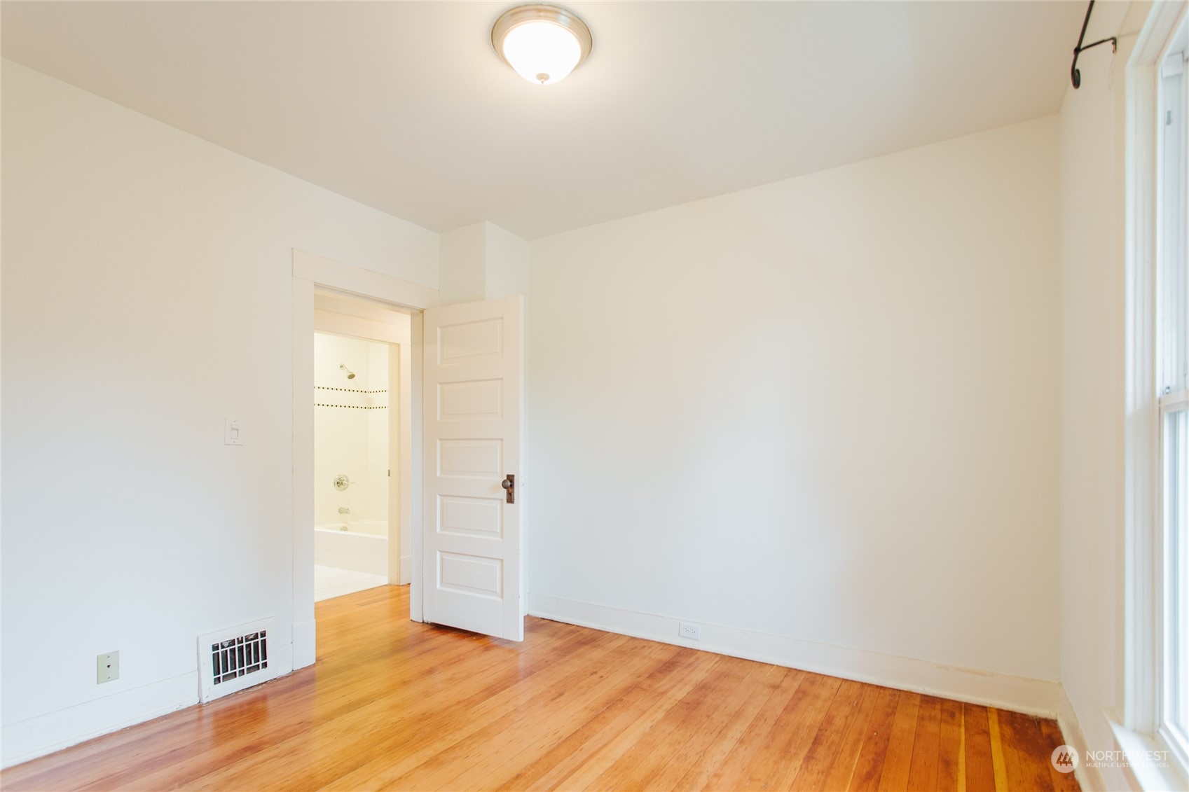 4122 Whitman Avenue North Seattle, WA 98103 - Photo 22 of 28 a view of an empty room and wooden floor