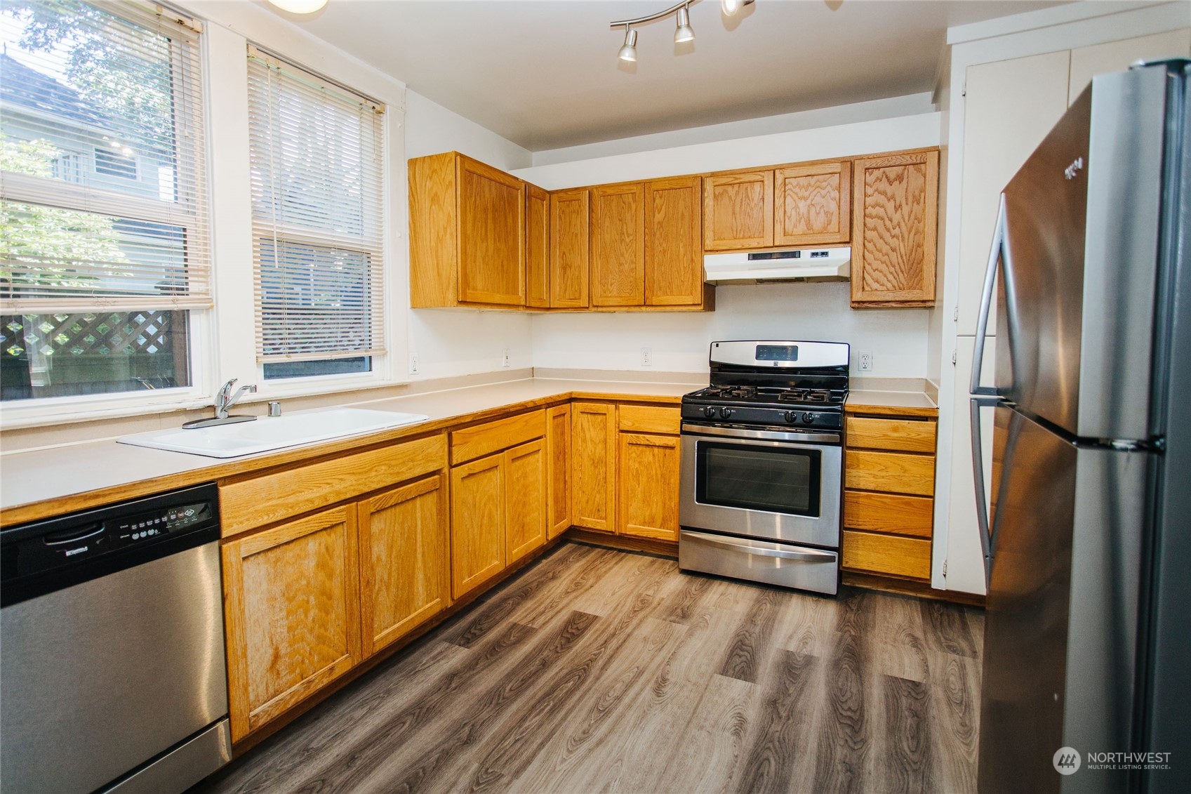 4122 Whitman Avenue North Seattle, WA 98103 - Photo 4 of 28 a kitchen with stainless steel appliances a stove sink and refrigerator