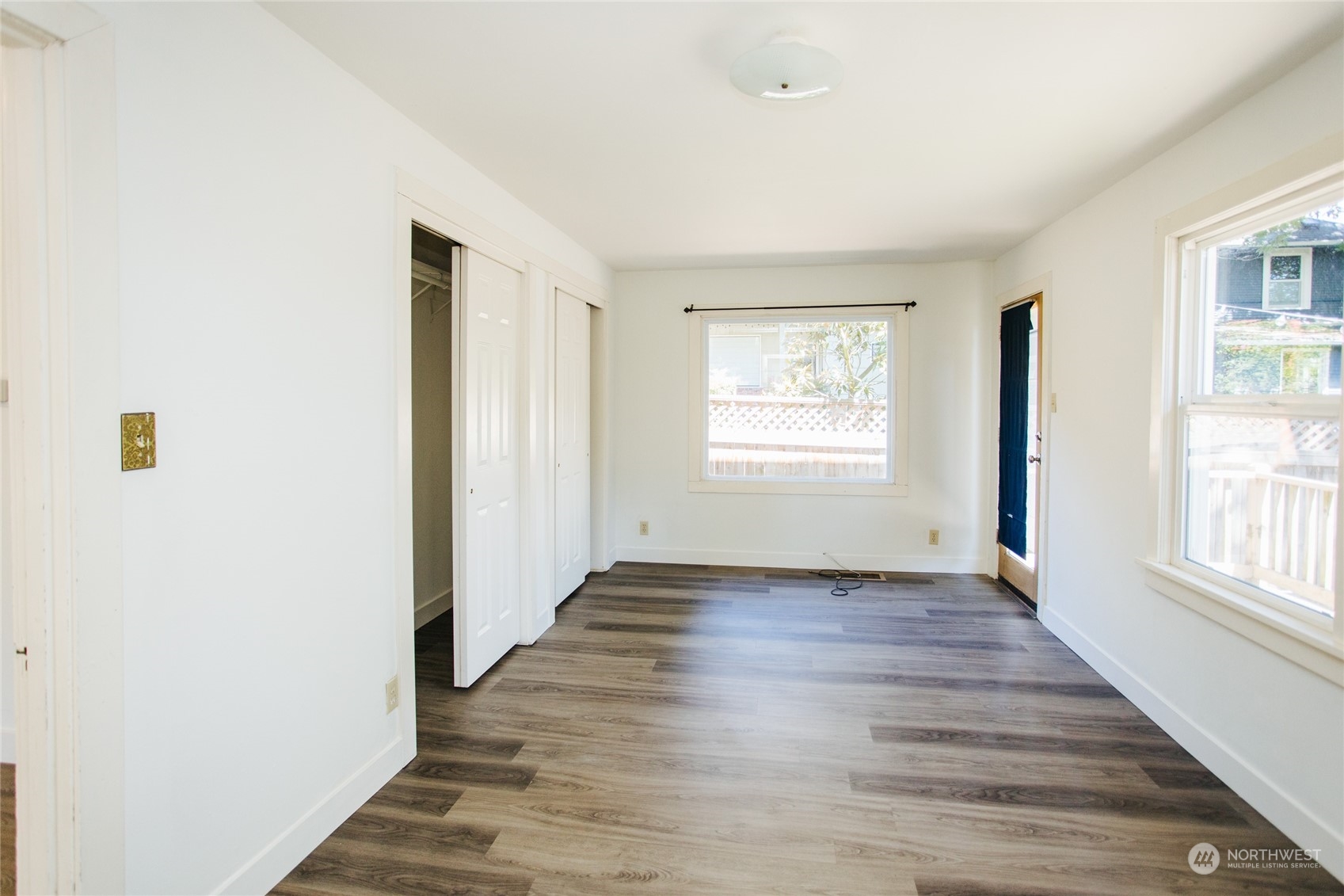 4122 Whitman Avenue North Seattle, WA 98103 - Photo 7 of 28 a view of an empty room with wooden floor and a window