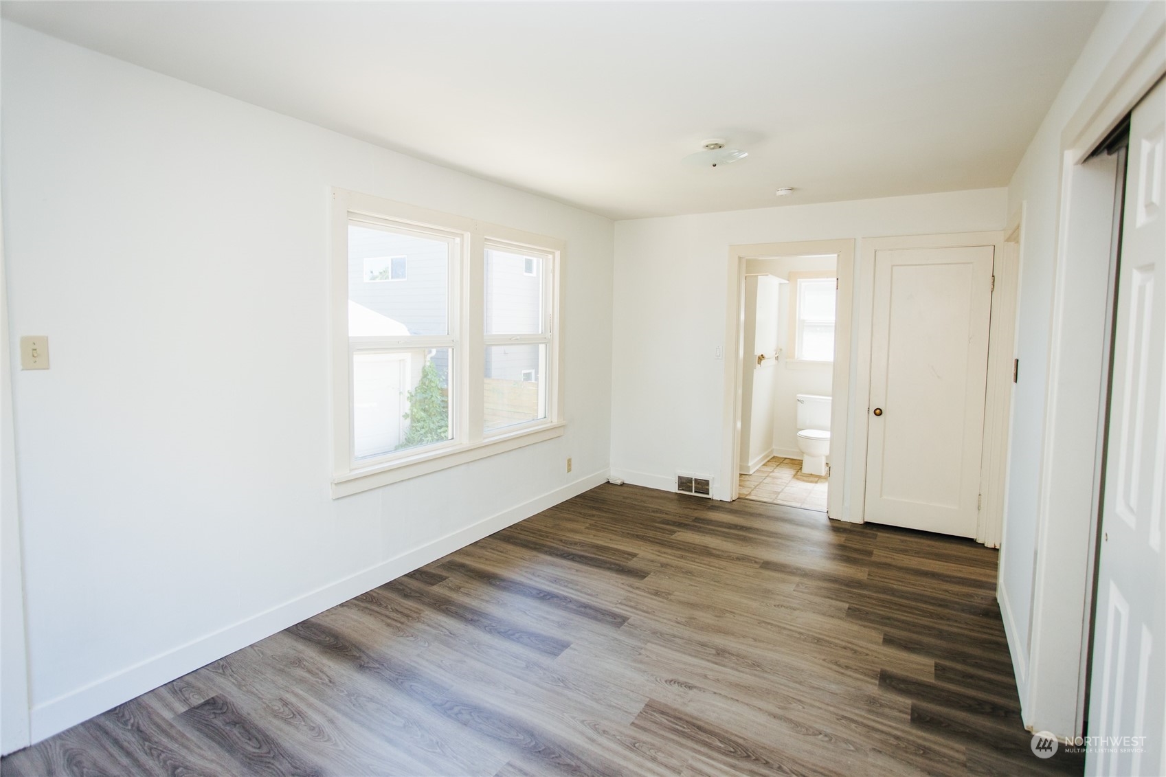 4122 Whitman Avenue North Seattle, WA 98103 - Photo 8 of 28 a view of an empty room with wooden floor and a window