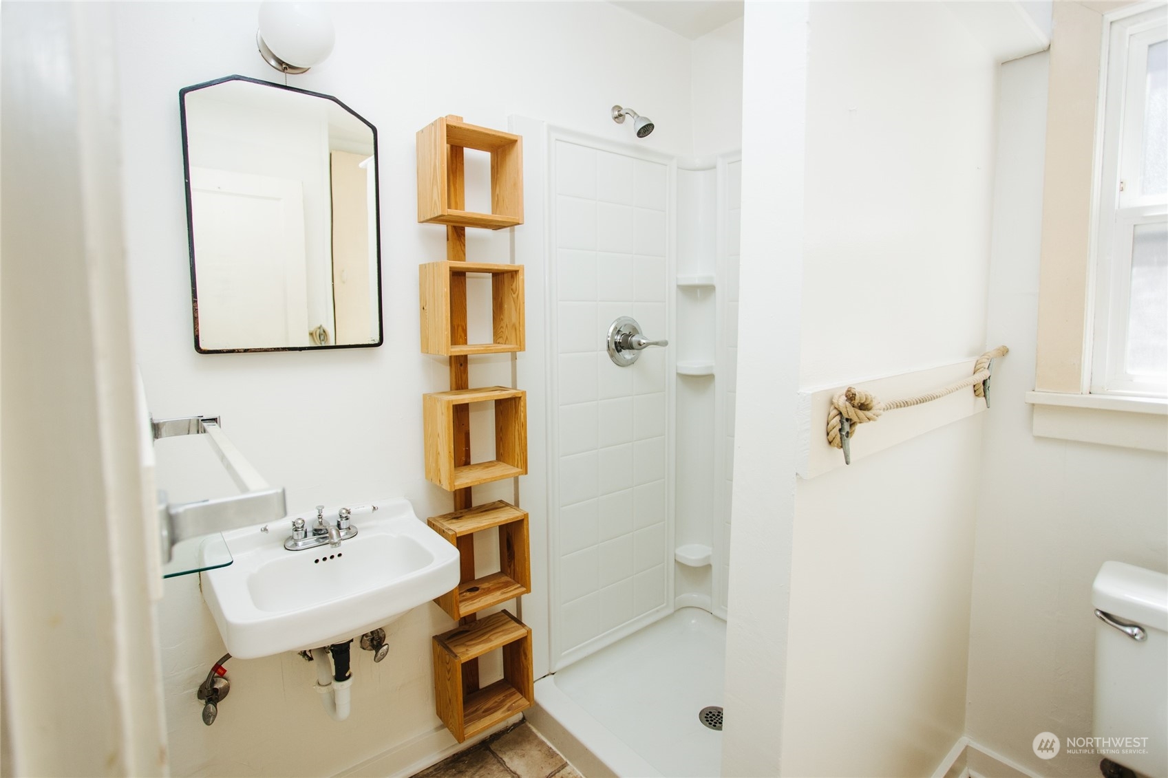 4122 Whitman Avenue North Seattle, WA 98103 - Photo 9 of 28 a bathroom with a sink mirror toilet and shower