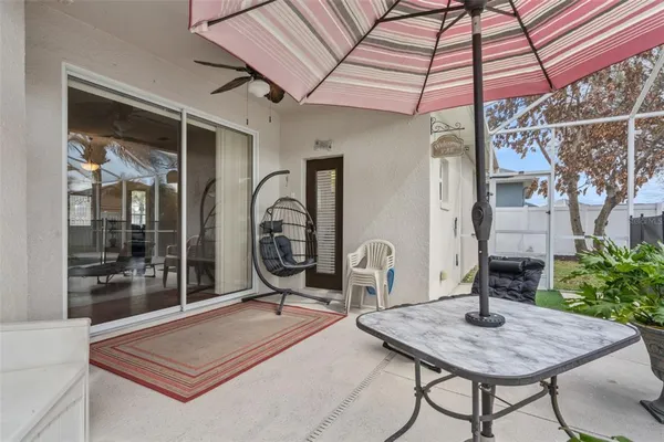 a backyard of a house with barbeque oven table and chairs