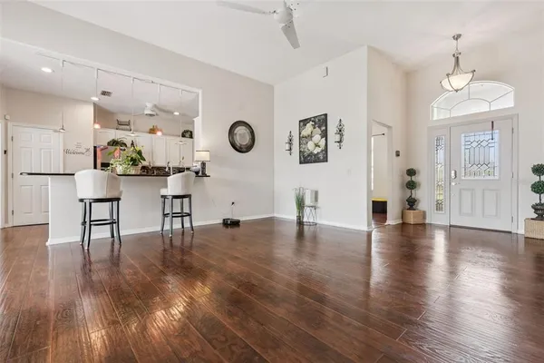 a living room with furniture and wooden floor