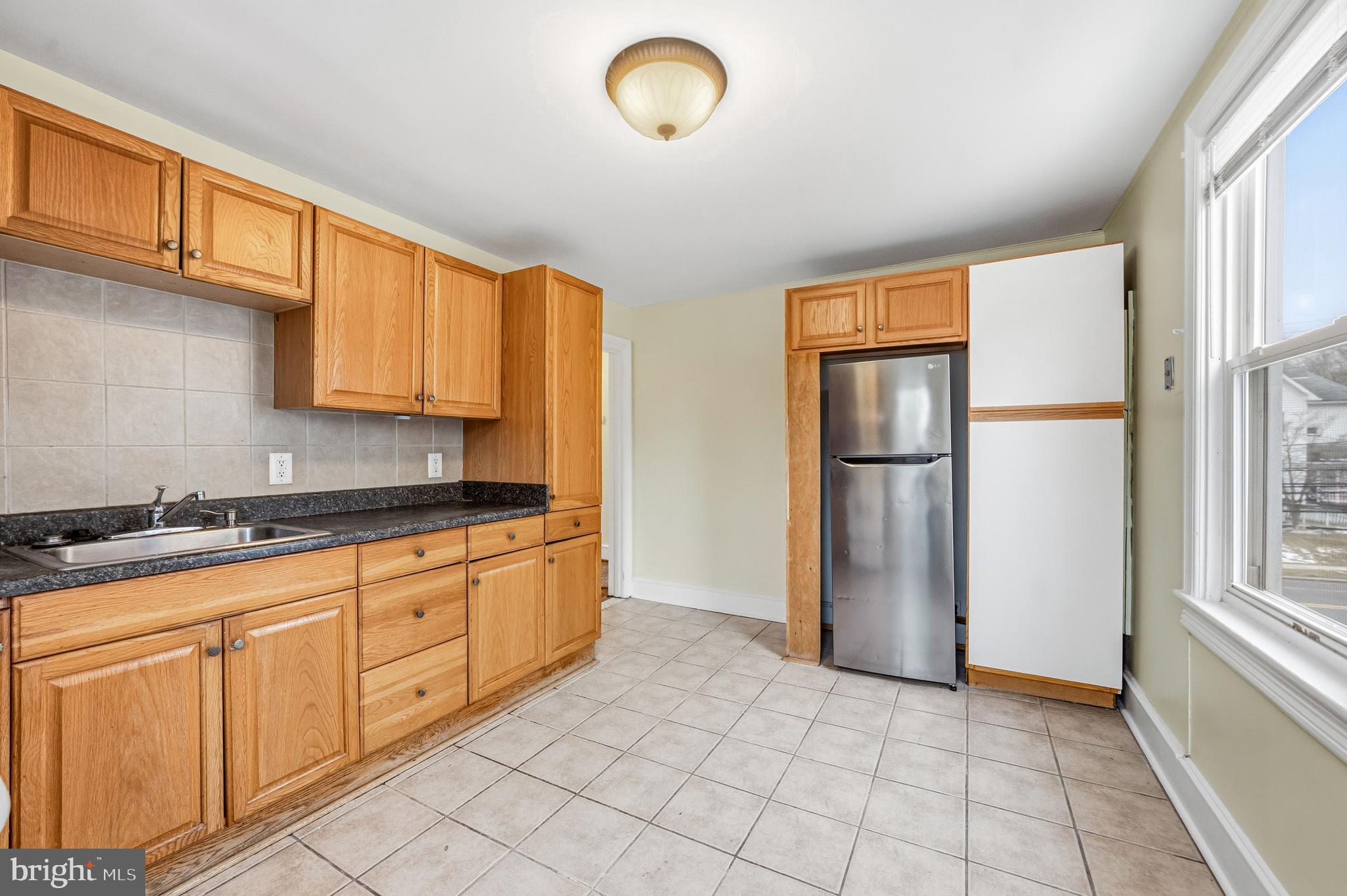 213 South Church Street Moorestown, NJ 08057 - Photo 35 of 54 a kitchen with granite countertop a refrigerator and cabinets