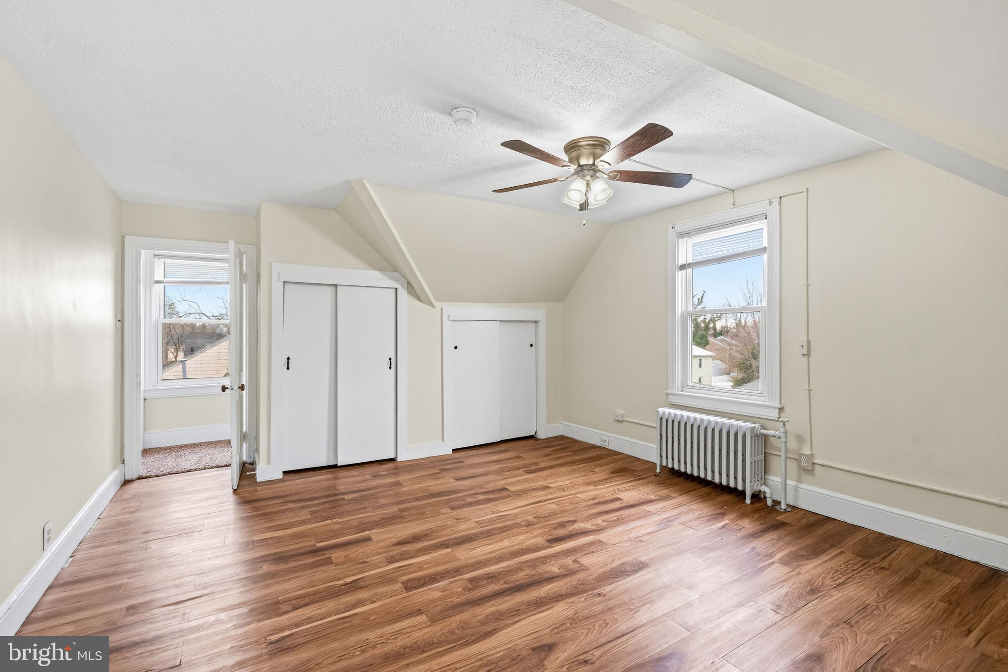 213 South Church Street Moorestown, NJ 08057 - Photo 40 of 54 an empty room with wooden floor chandelier fan and windows