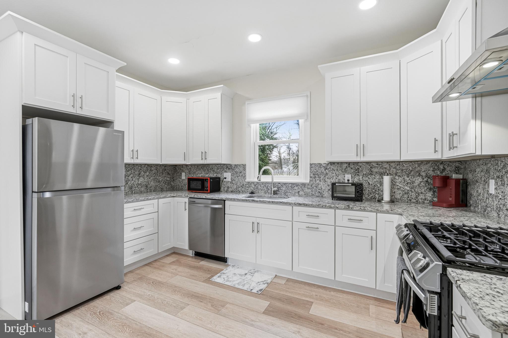 213 South Church Street Moorestown, NJ 08057 - Photo 6 of 54 a kitchen with white cabinets and white appliances