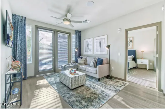 a living room with furniture and a large window