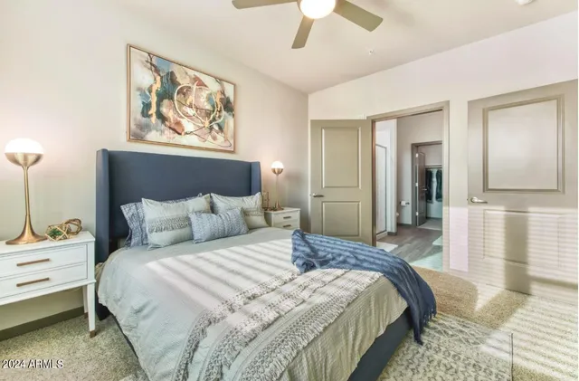 a bedroom with a bed and a painting on the wall