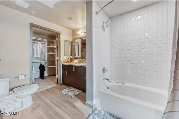 a bathroom with a bathtub shower sink and toilet