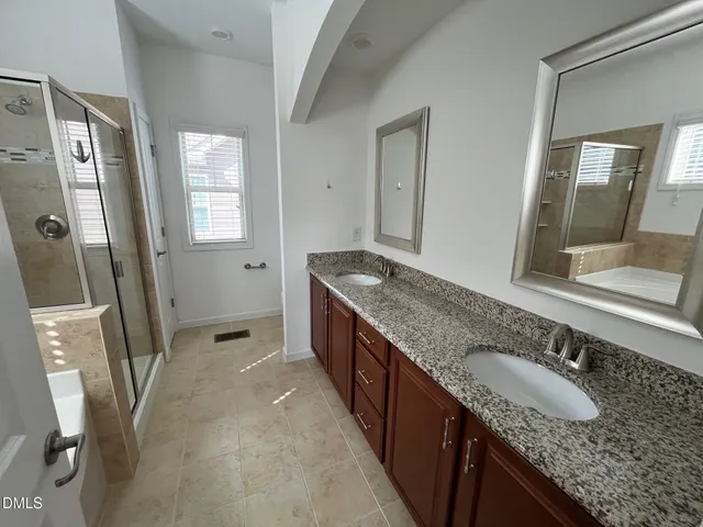 a bathroom with a bathtub and a shower