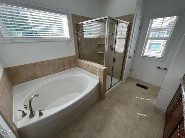 a bathroom with a granite countertop sink a toilet and bathtub