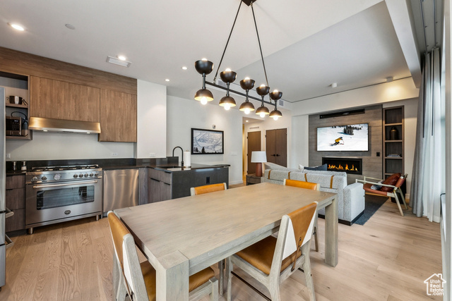 2417 West High Mountain Road, Unit 2202 Park City, UT 84098 - Photo 7 of 28 Dining room with sink, a fireplace, built in shelves, and light hardwood / wood-style flooring