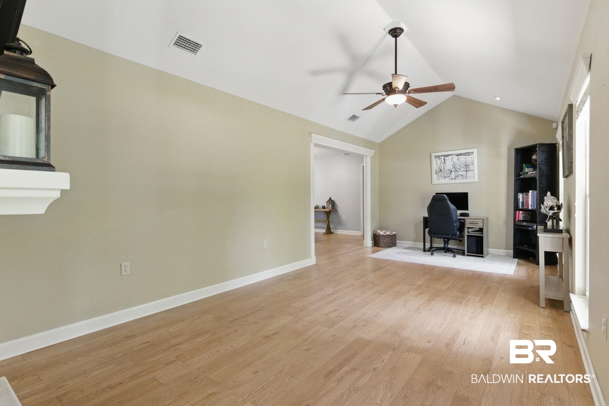 32345 River Lake Road Seminole, AL 36574 - Photo 19 of 56 Living room featuring baseboards, vaulted ceiling, visible vents, ceiling fan, and light wood finished floors