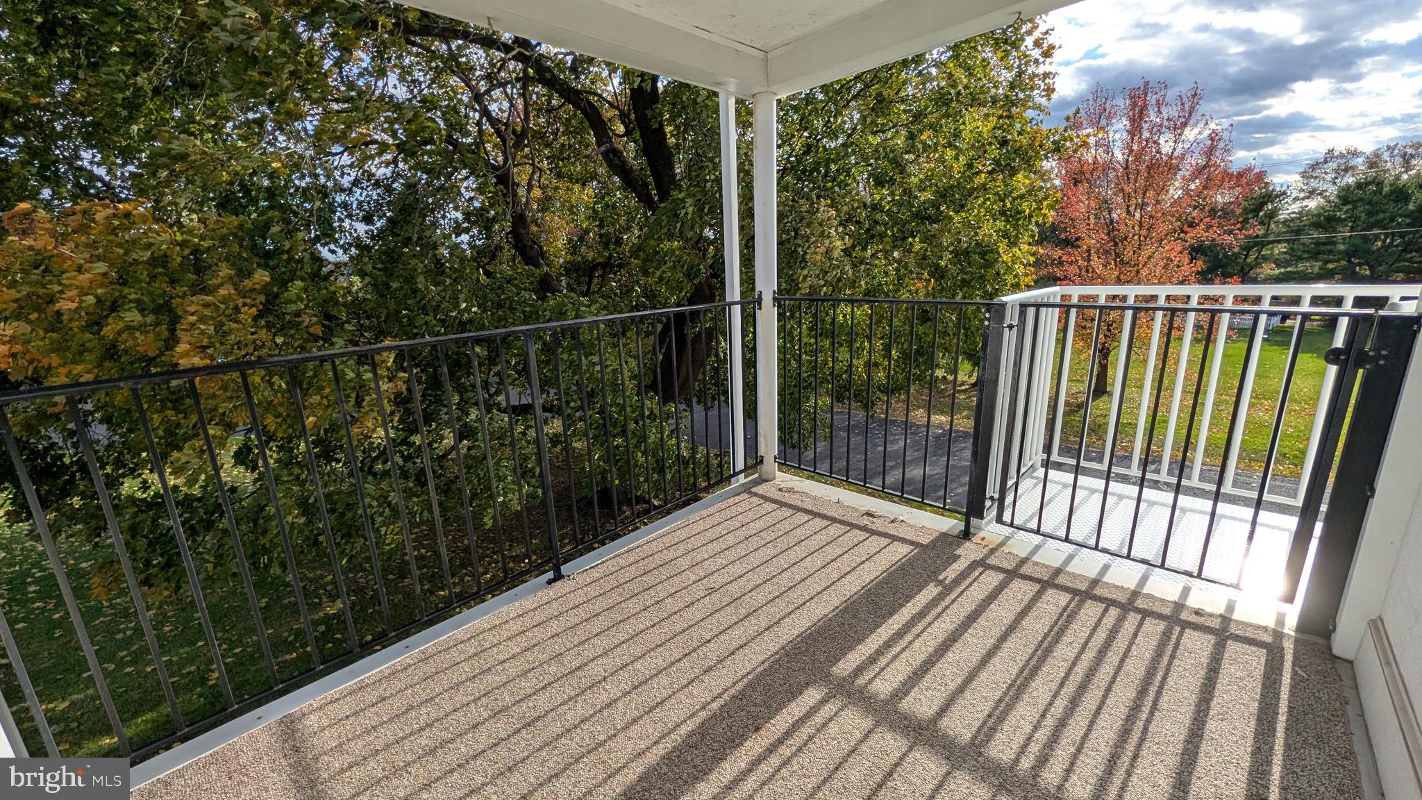 302 Leidy Road, Unit 2 Souderton, PA 18964 - Photo 14 of 23 a view of a balcony with wooden floor and fence