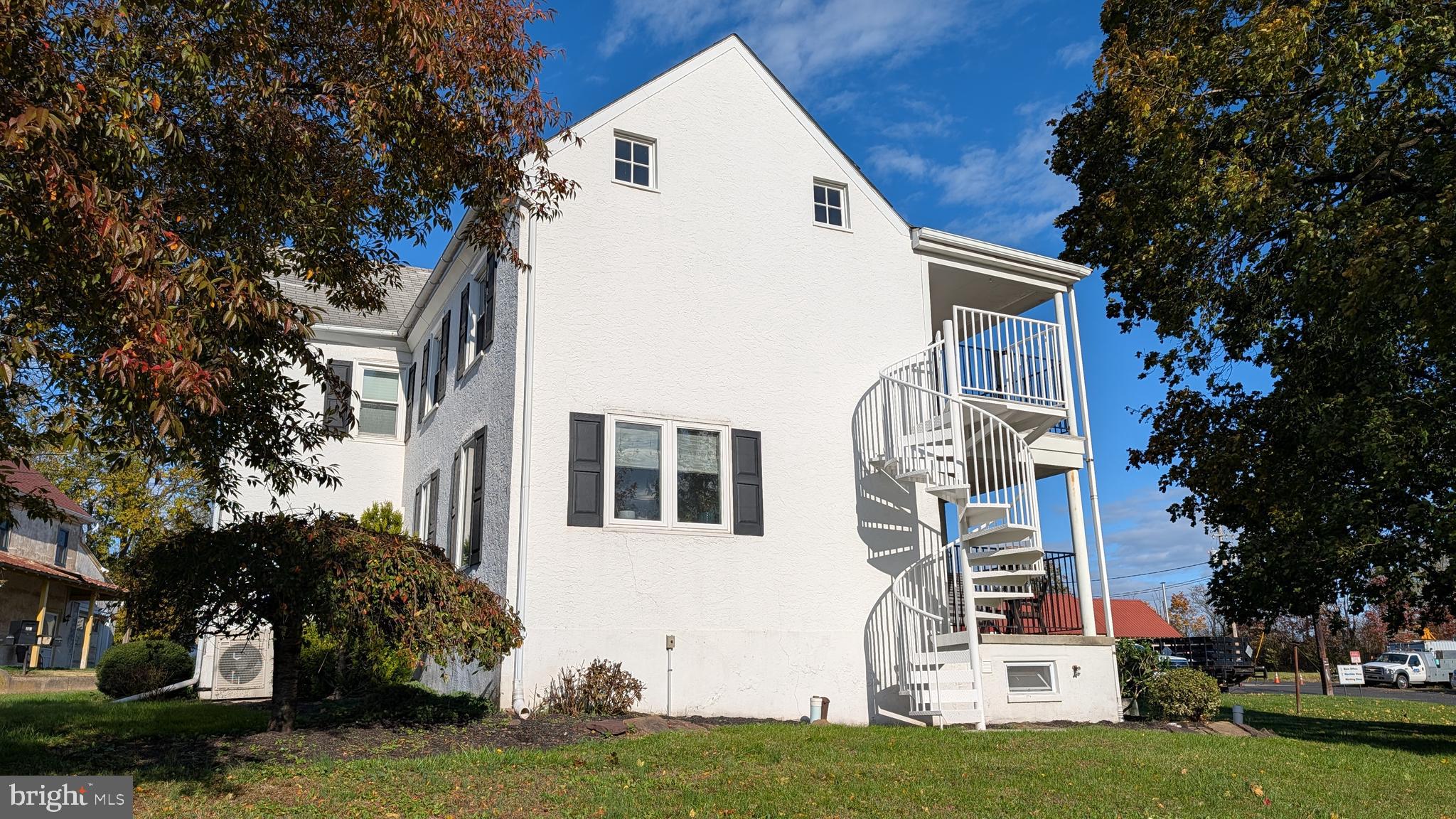 302 Leidy Road, Unit 2 Souderton, PA 18964 - Photo 3 of 23 a view of a white house with a big yard and large trees