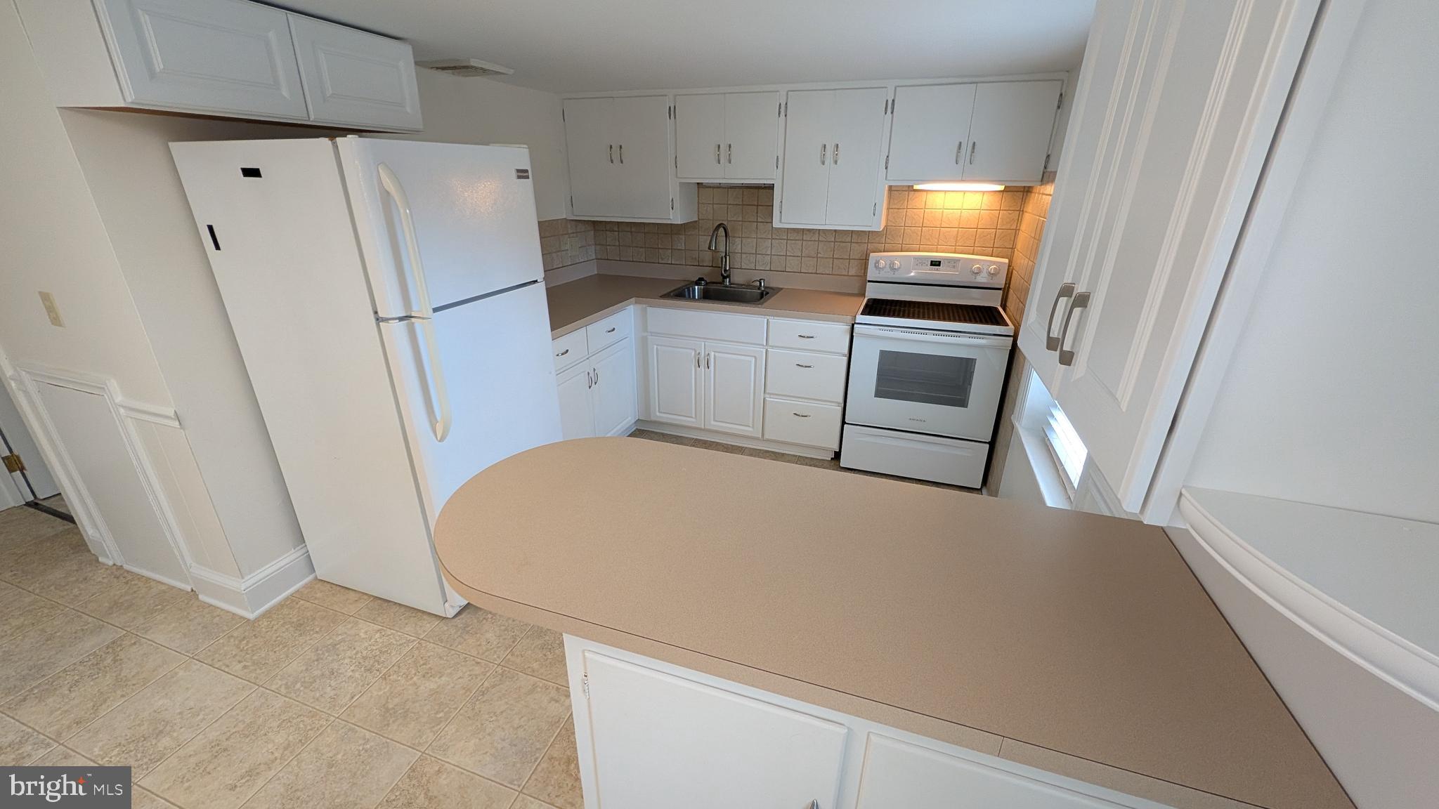 302 Leidy Road, Unit 2 Souderton, PA 18964 - Photo 6 of 23 a kitchen with stainless steel appliances a refrigerator and a stove