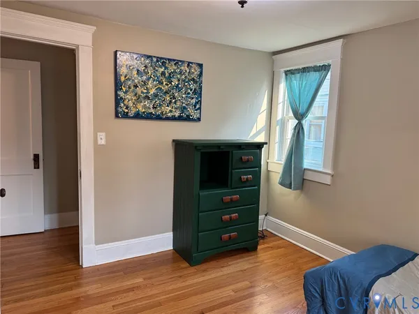 a room with a dresser with wooden floor