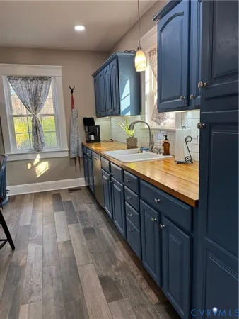 a kitchen with a sink and wooden cabinets