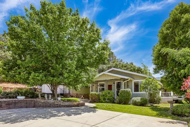 a front view of a house with a garden