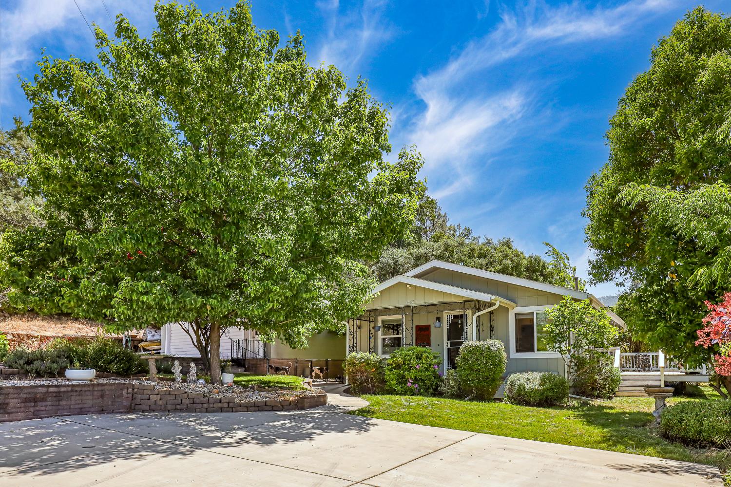 a front view of a house with a garden