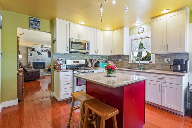 a view of a livingroom with furniture window and wooden floor