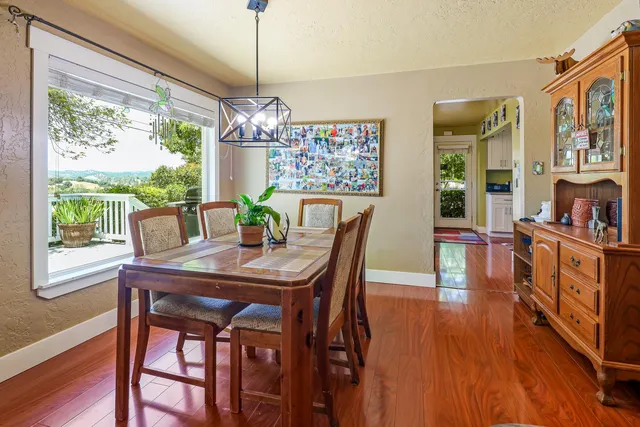 a living room with furniture a flat screen tv and wooden floor