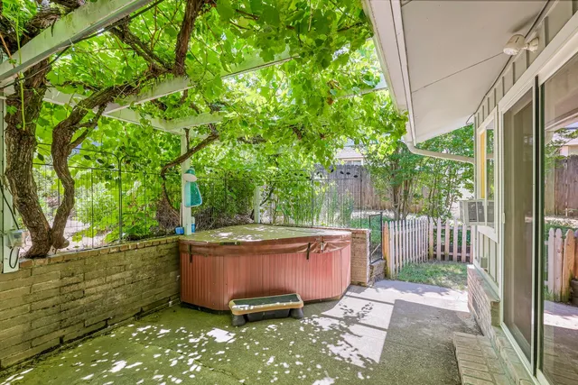 a view of a patio with table and chairs and potted plants