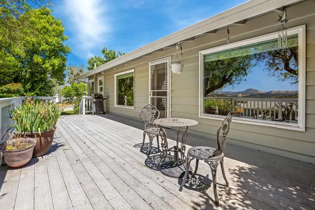 a view of a backyard with garden and patio