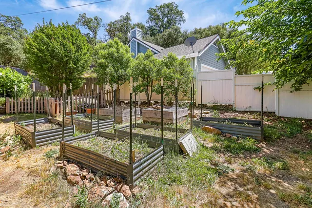 an aerial view of a house with a yard and garden