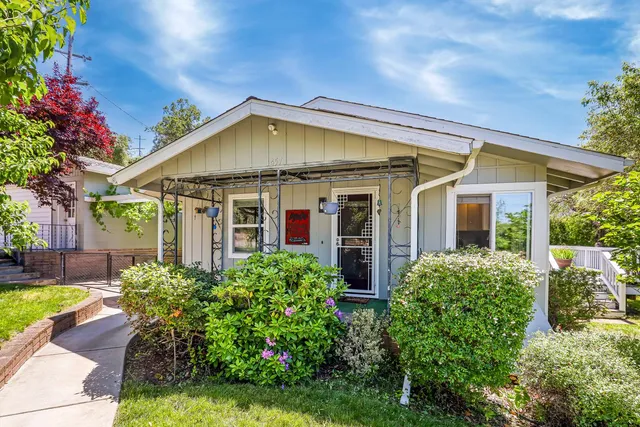 a kitchen with granite countertop a sink cabinets and window
