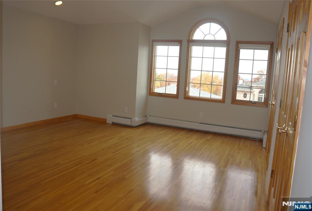 520 7th Street, Unit B Palisades Park, NJ 07650 - Photo 12 of 22 an empty room with wooden floor and windows