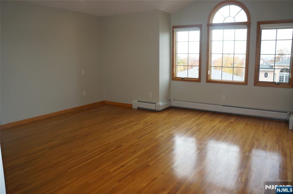 520 7th Street, Unit B Palisades Park, NJ 07650 - Photo 15 of 22 an empty room with wooden floor and windows