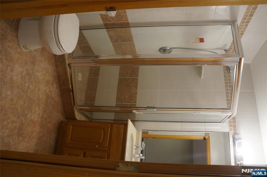 520 7th Street, Unit B Palisades Park, NJ 07650 - Photo 21 of 22 a bathroom with a shower a toilet and a sink
