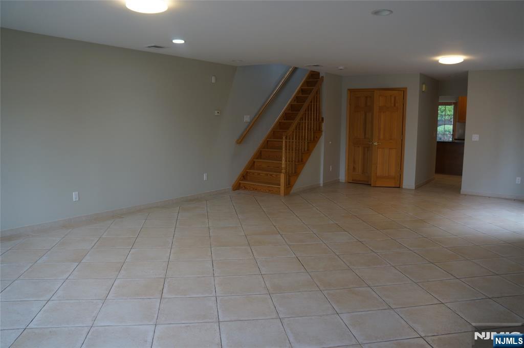 520 7th Street, Unit B Palisades Park, NJ 07650 - Photo 4 of 22 an empty room with white walls and stairs