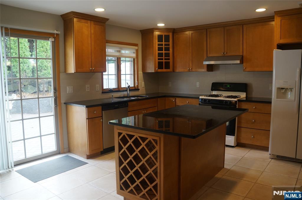 520 7th Street, Unit B Palisades Park, NJ 07650 - Photo 6 of 22 a kitchen with kitchen island granite countertop a sink stove and refrigerator