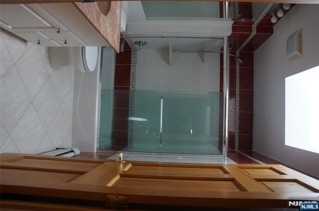 520 7th Street, Unit B Palisades Park, NJ 07650 - Photo 10 of 22 a bathroom with a shower a toilet and sink