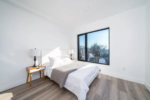 a bedroom with a bed and a window